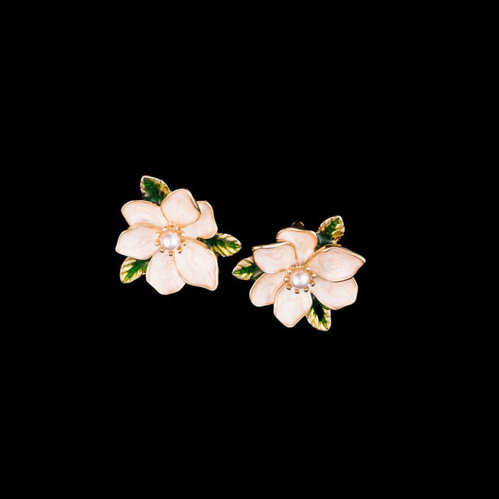 Magnolia Flower-shaped earrings on a black background