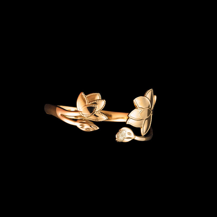 Gold magnolia floral cuff on a black background