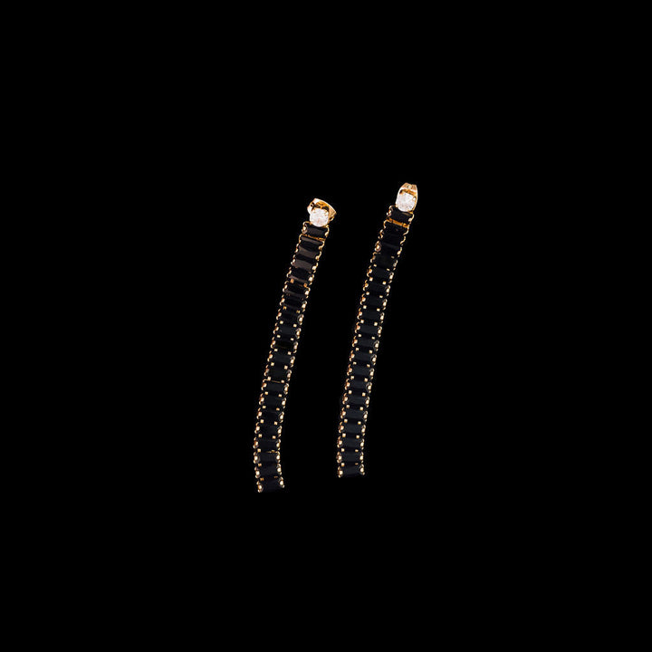 Pair of black earrings on a black background