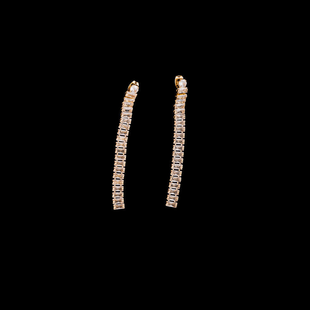 Pair of gold hoop earrings on a black background
