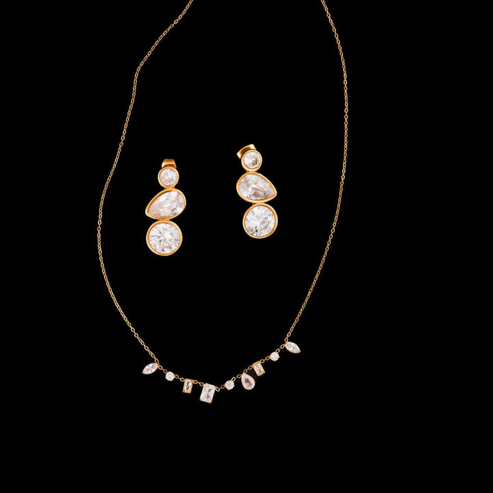 Gold necklace with matching earrings on a black background