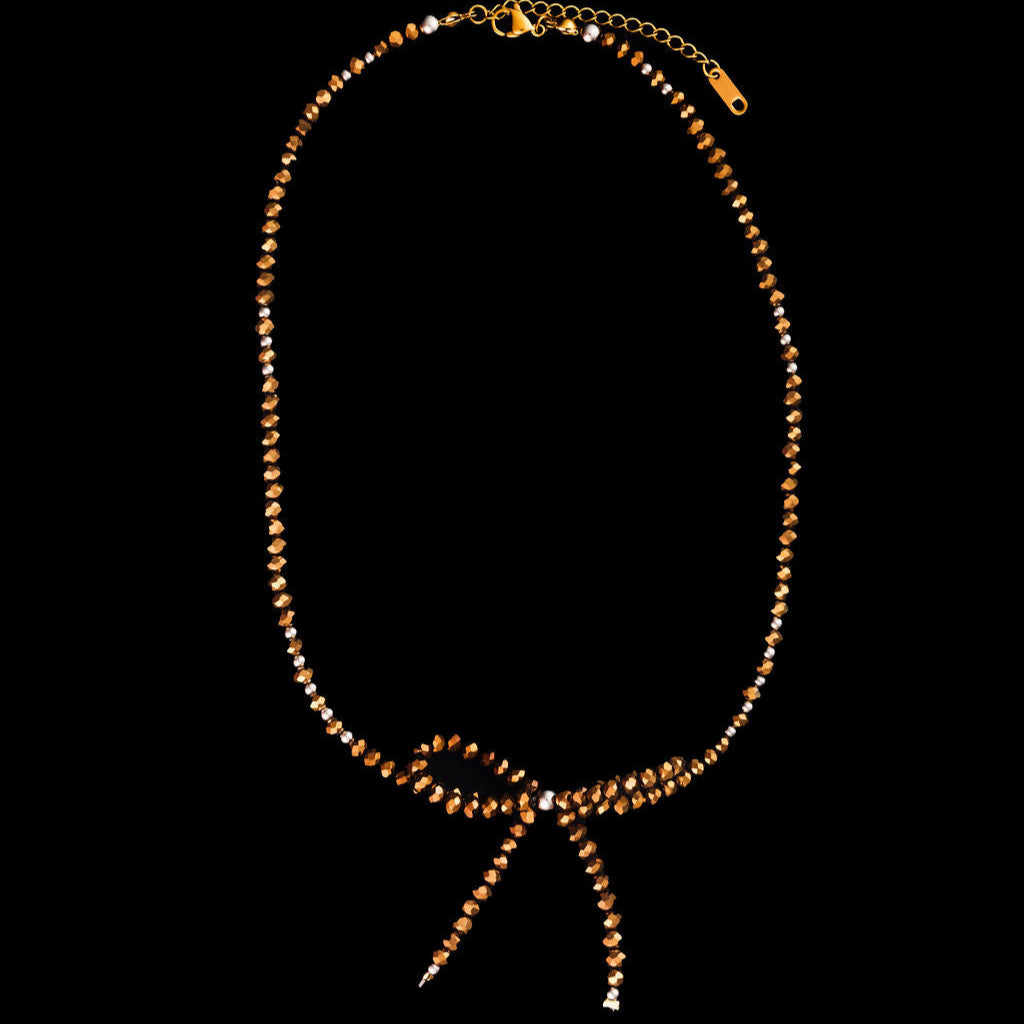 Necklace with a bow on a black background