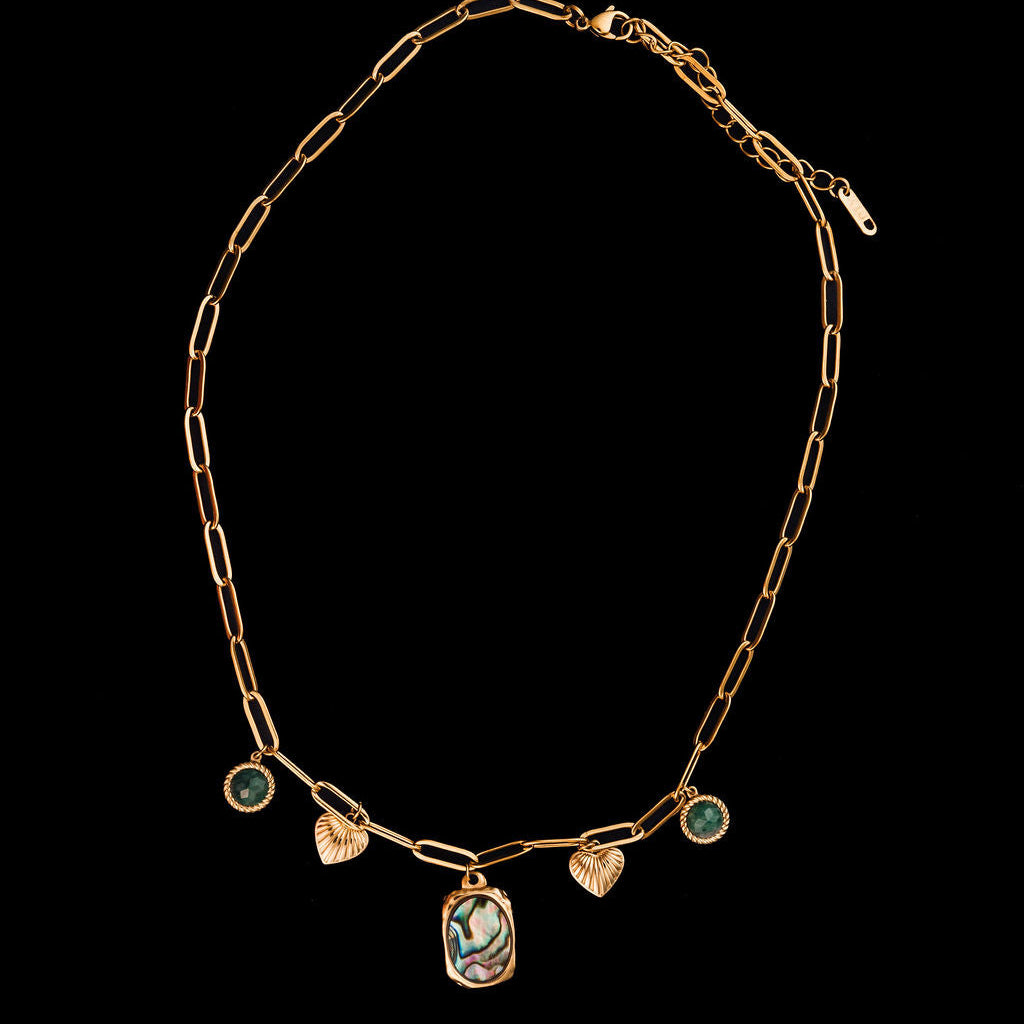Gold necklace with heart-shaped pendants on a black background