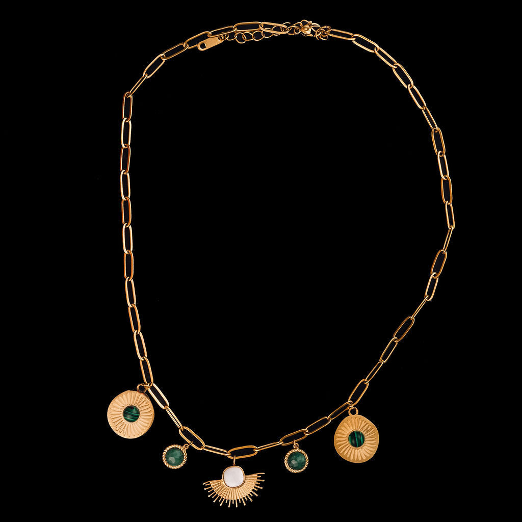 Gold necklace with circular pendants on a black background