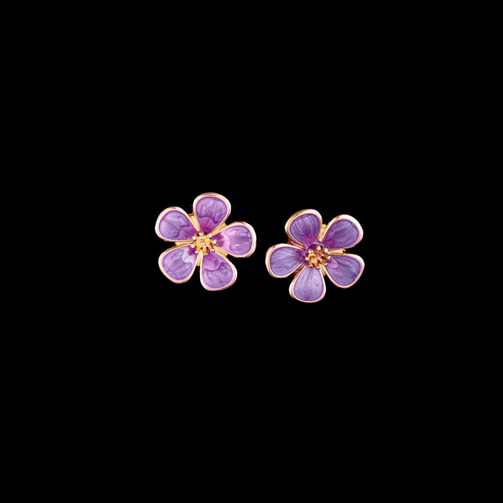 Purple daisy flower-shaped earrings on a black background