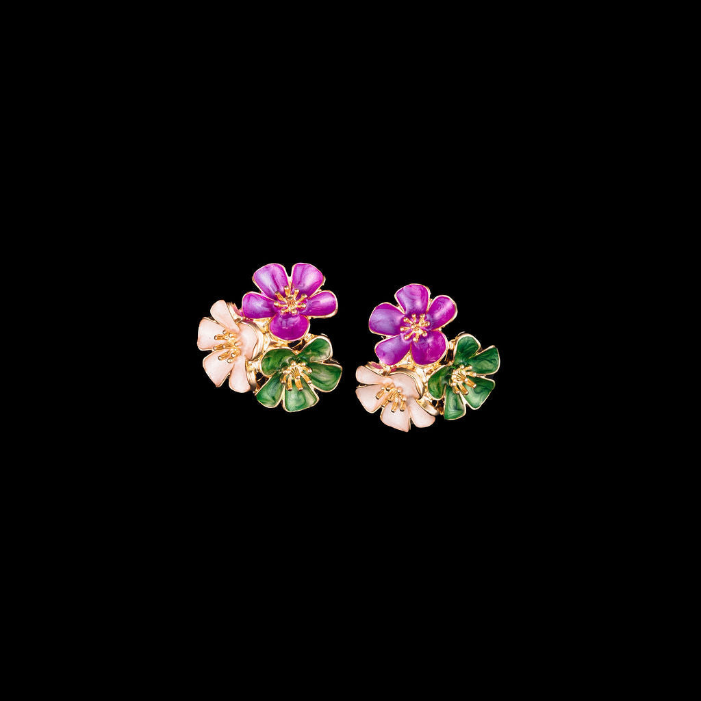 Floral earrings with purple, green and white flowers on a black background